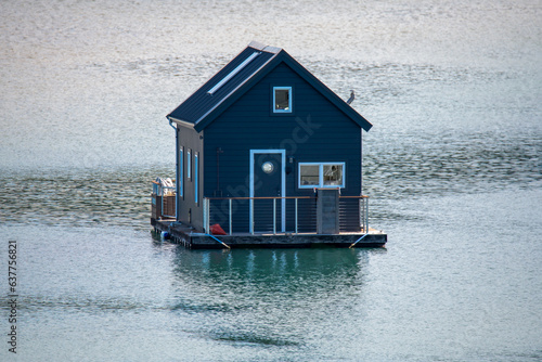 Photos A dark blue houseboat on the Pittwater