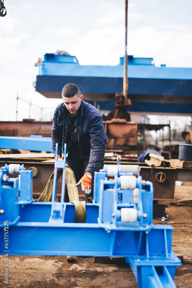 Manual worker working at shipyard construction site Manual worker working at shipyard construction site