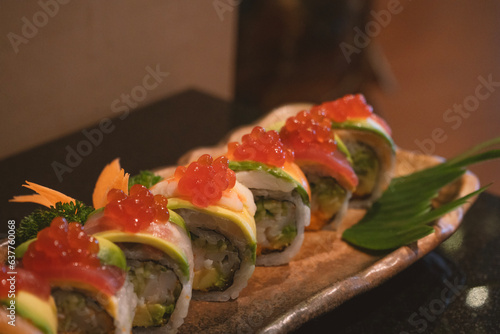 Sushi Rolls with eel, salmon, avocado, flying fish caviar and Cream Cheese inside isolated on white