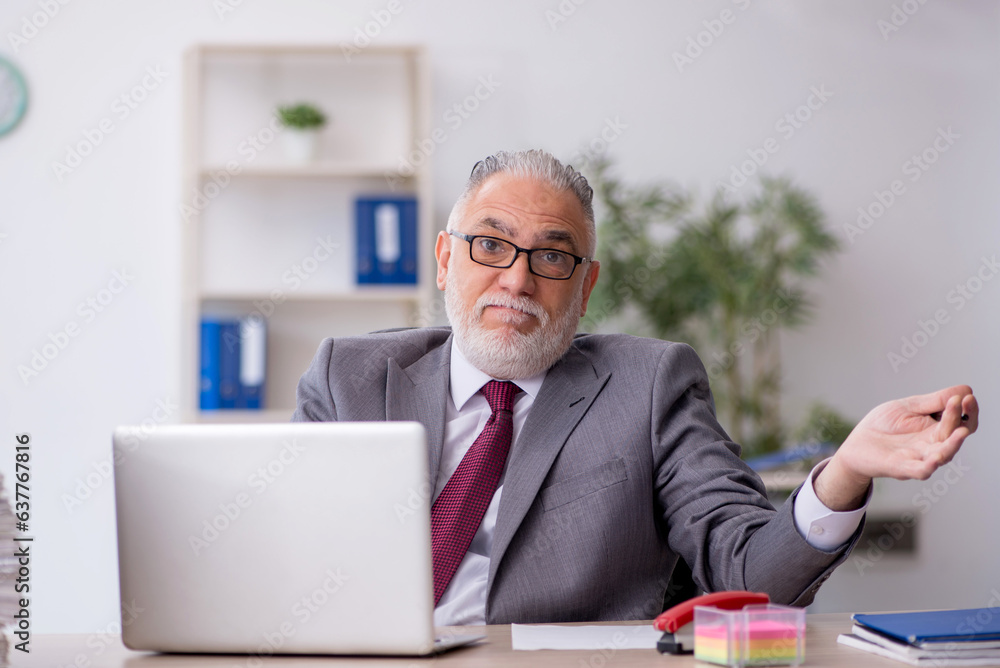 Old male employee and too much work in the office Old male employee and too much work in the office