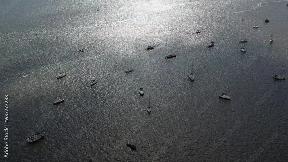 Aerial drone shot, looking down on the Exe Estuary showing beautiful shimmering water and moored up boats in Devon, UK Aerial drone shot, looking down on the Exe Estuary showing beautiful shimmering water and moored up boats in Devon, UK
