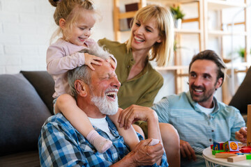 Cheerful multi-generation family having fun while spending time together at home.