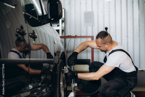 Wheel alignment ,Car on stand with sensors on wheels for wheels alignment camber check in workshop of Service station.