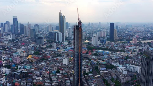 High-rise Condominium Tower Under Construction In Bang Rak, Bangkok, Thailand. aerial ascend photo