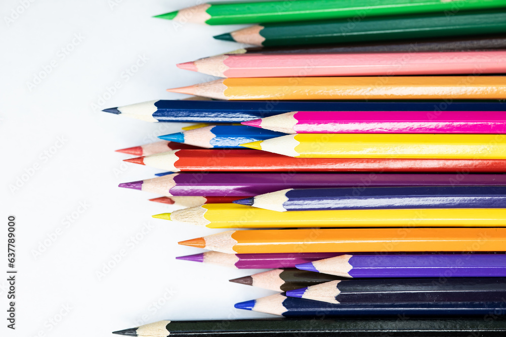 Wallpaper. Colored pencils on a white background. Set of pencils for illustrations, art, study. Concept: back to school. Rainbow, variety, mockup, copy space