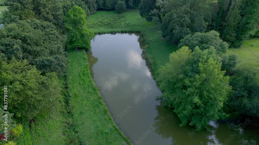 Aerial drone view of small rectangular shaped lake in lush green forest of Brittany in France Aerial drone view of small rectangular shaped lake in lush green forest of Brittany in France