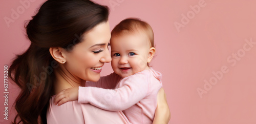 Portrait of a mother and child on pink background with copy space for text