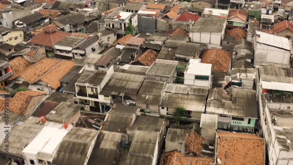 Aerial tilt down shot of old destroyed roof of slum buildings in Jakarta City, Indonesia 
