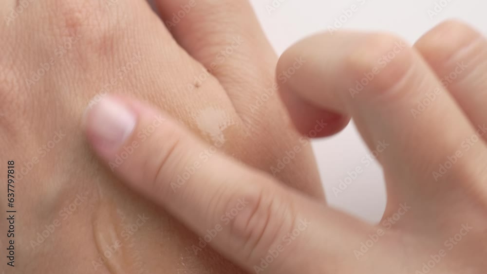 Female hands care. Close up of woman applying serum gel on hand skin. Serum oil with hyaluronic acid applied by a woman's hand, skin care cosmetics, moisturizing gel. Female hands care. Close up of woman applying serum gel on hand skin. Serum oil with hyaluronic acid applied by a woman's hand, skin care cosmetics, moisturizing gel.