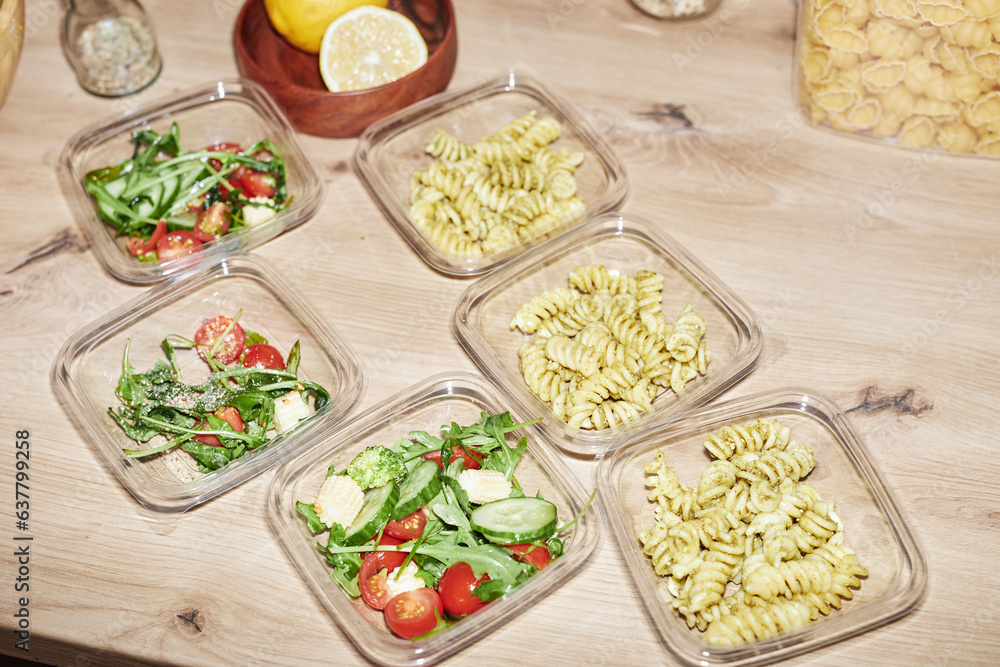 Background image of plastic containers with food servings on wooden kitchen counter, meal prep