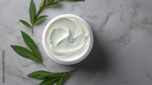 Tube of green cream on marble table with cannabis sativa leaves Cosmetic mockup Organic skincare Hemp body or hand cream photo