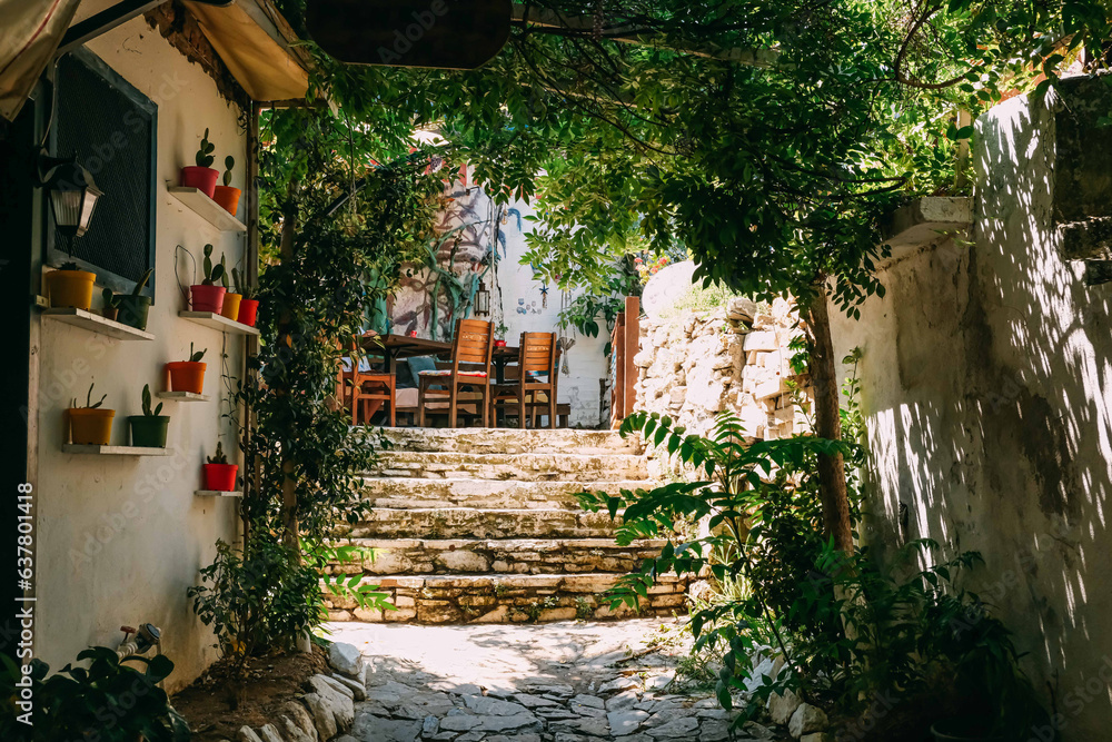A narrow stone hillside alley with shops and homes in the ancient village of Sirince, Turkey