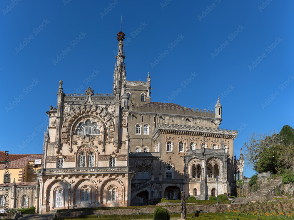 Full view of the back facade of the Bussaco Palace, Romantic palace in Neo-Manueline style monument, romantia« classic gardens and blue sky, in Portugal