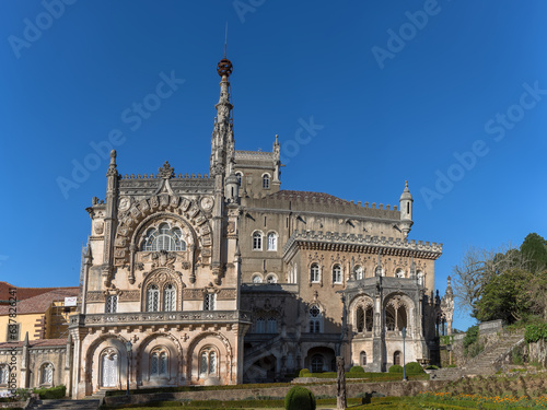 Full view of the back facade of the Bussaco Palace, Romantic palace in Neo-Manueline style monument, romantia« classic gardens and blue sky, in Portugal