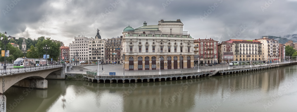 Panoramic exterior view at the Arriaga square, an iconic plaza on Casco Viejo, Arriaga Theatre, bridge and Nervión river Bilbao downtown city, Spain