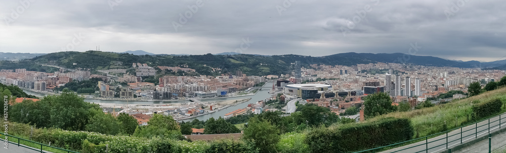 Aerial panoramic view at the full Bilbao downtown city, Nervion river and river banks and iconic buildings