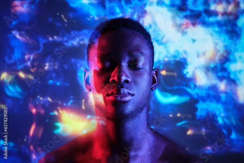 Emotionless shirtless black man with eyes closed in neon lights