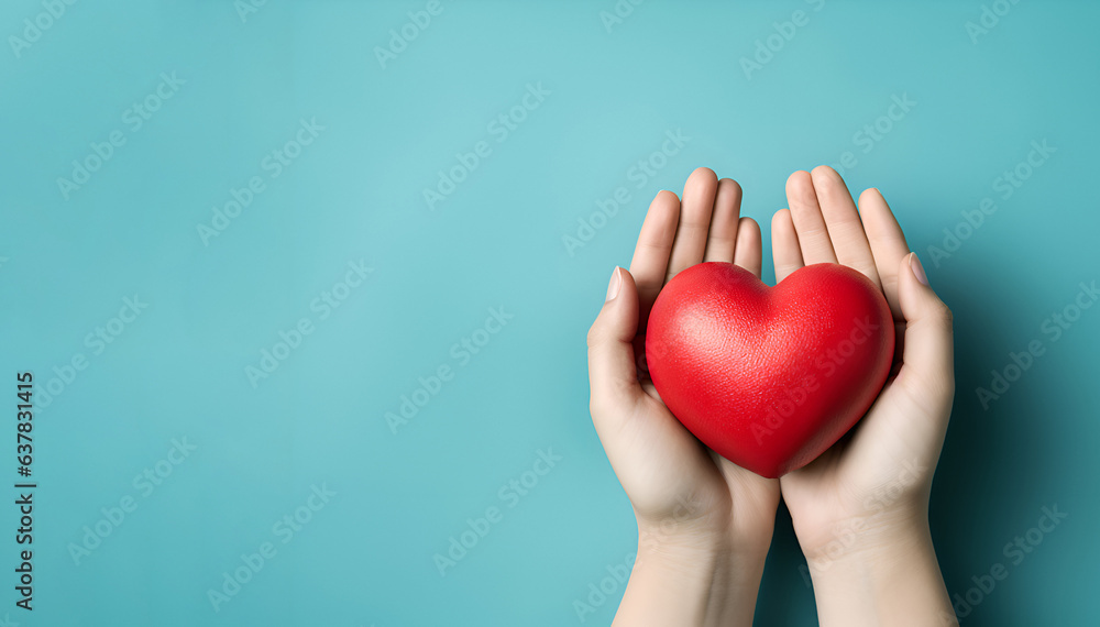 Red heart in hands on a blue background Red heart in hands on a blue background