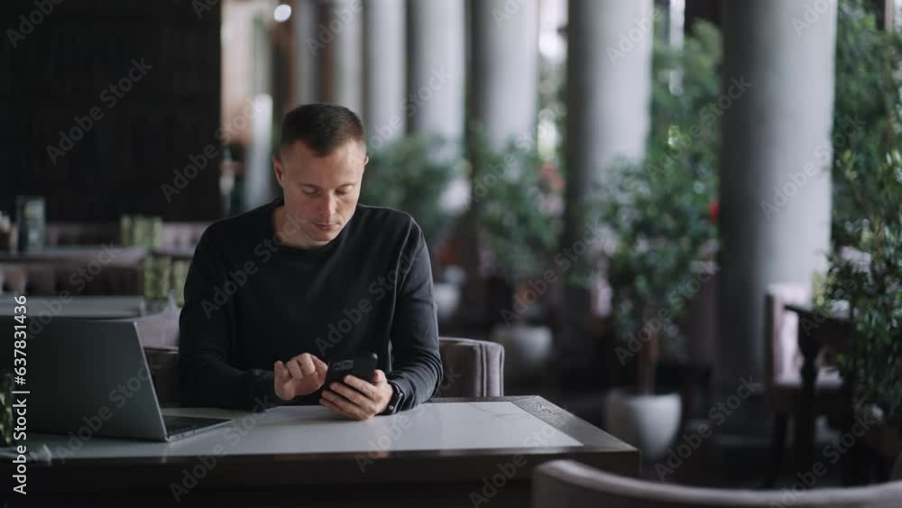 Portrait Of Businessman With Modern Smartphone In Cafe, Freelancer Using New Mobile App Portrait Of Businessman With Modern Smartphone In Cafe, Freelancer Using New Mobile App