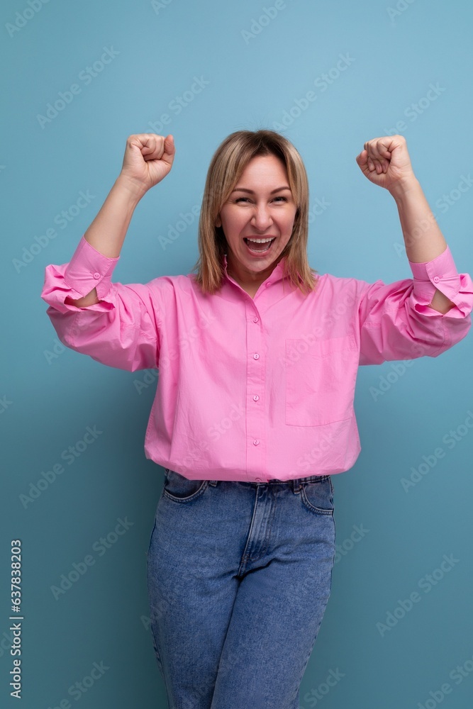 young pretty blond european office worker woman with flowing hair in a pink blouse smiles sweetly young pretty blond european office worker woman with flowing hair in a pink blouse smiles sweetly