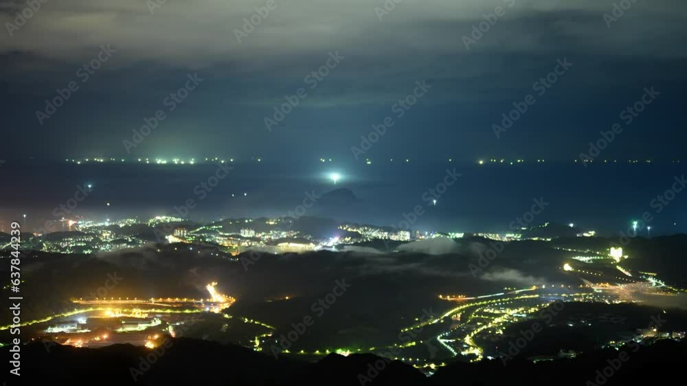 A dreamy night view surrounded by clouds. A village by the mountains and the sea The Wufenshan Weather Radar Station stands on the top of the mountain. Taiwan A dreamy night view surrounded by clouds. A village by the mountains and the sea The Wufenshan Weather Radar Station stands on the top of the mountain. Taiwan