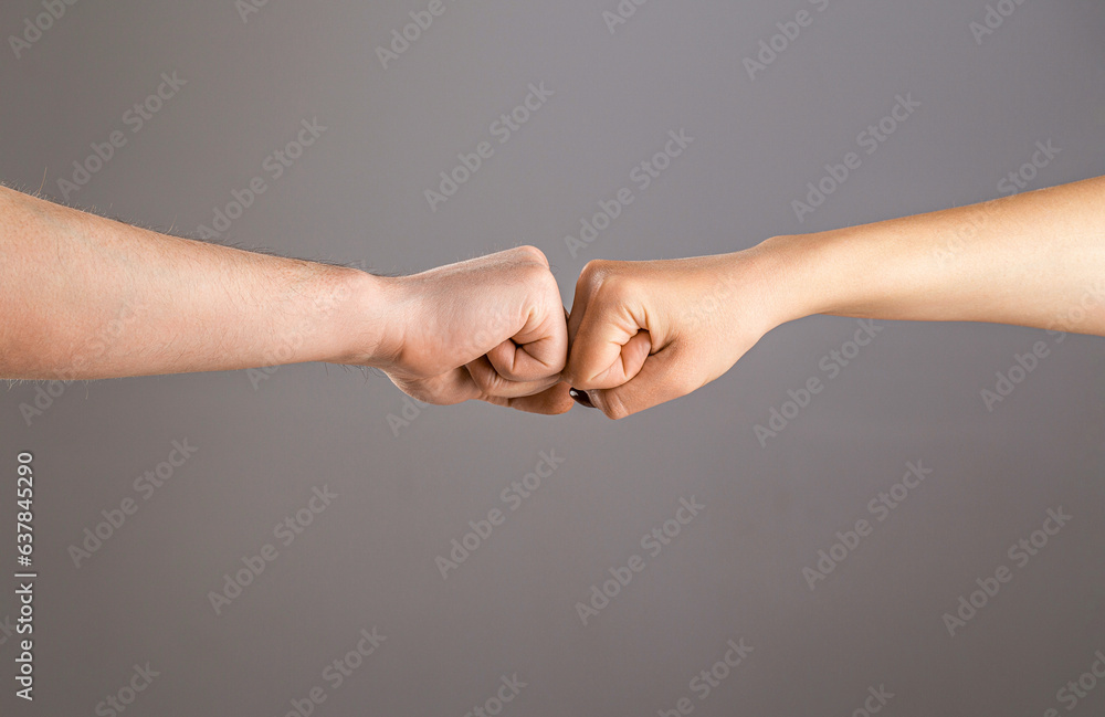 Man and woman are fist bumping. Fist Bump. Clash of two fists, vs. Gesture of giving respect or approval. Friends greeting. Teamwork and friendship. Partnership concept. Male vs female hand