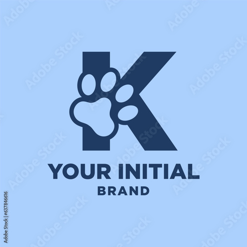 letter K paw print dog foot silhouette in negative space initial vector logo design