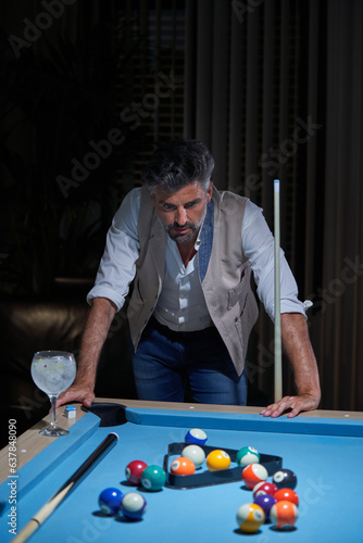 Gray haired billiard player thinking during pool game