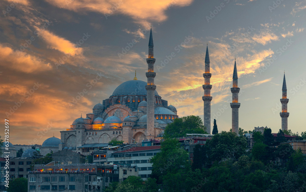 Beautiful view of gorgeous historical Suleymaniye Mosque, Rustem Pasa Mosque and buildings in front of dramatic sunset. Istanbul most popular tourism destination of Turkey