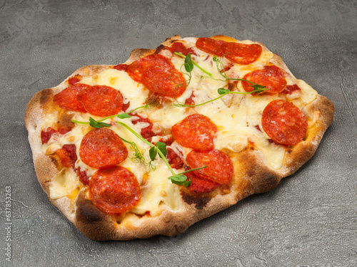 roman pizza with pepperoni on a gray background photo