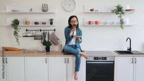 Female adult resting at home with vegetarian salad for lunch