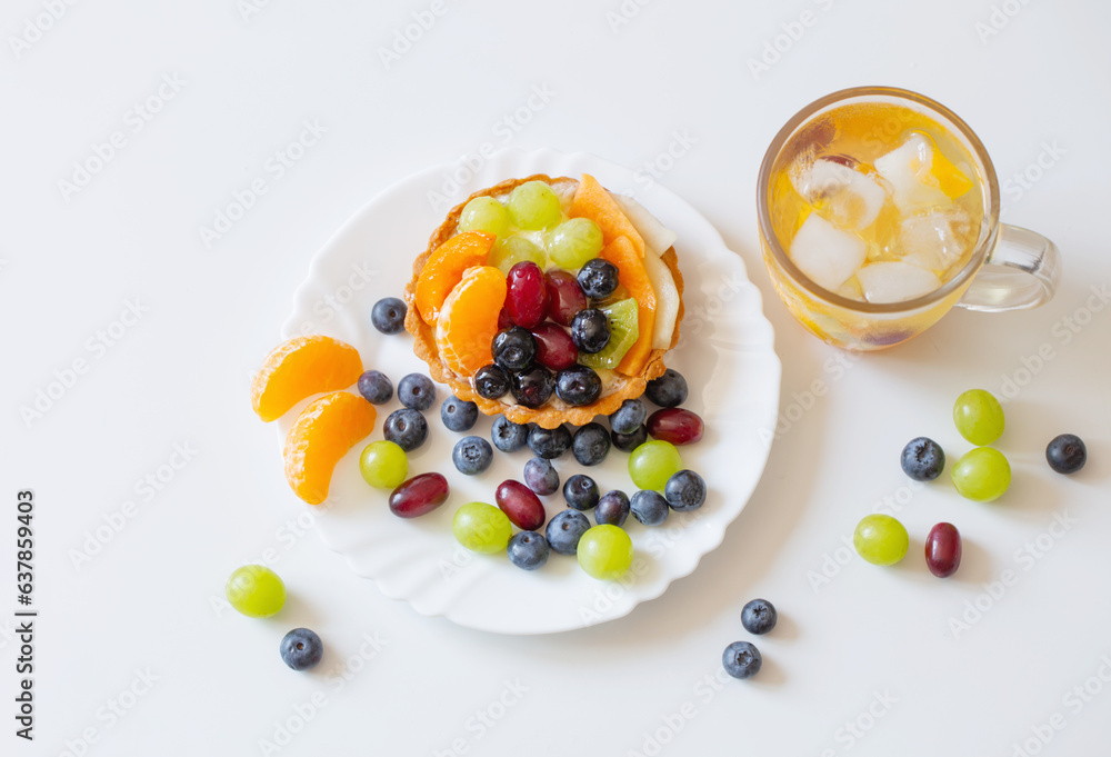 cupcakes with fruits and cold healthy drink on white table cupcakes with fruits and cold healthy drink on white table