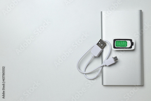 Powerbank and cord on white background, space for text