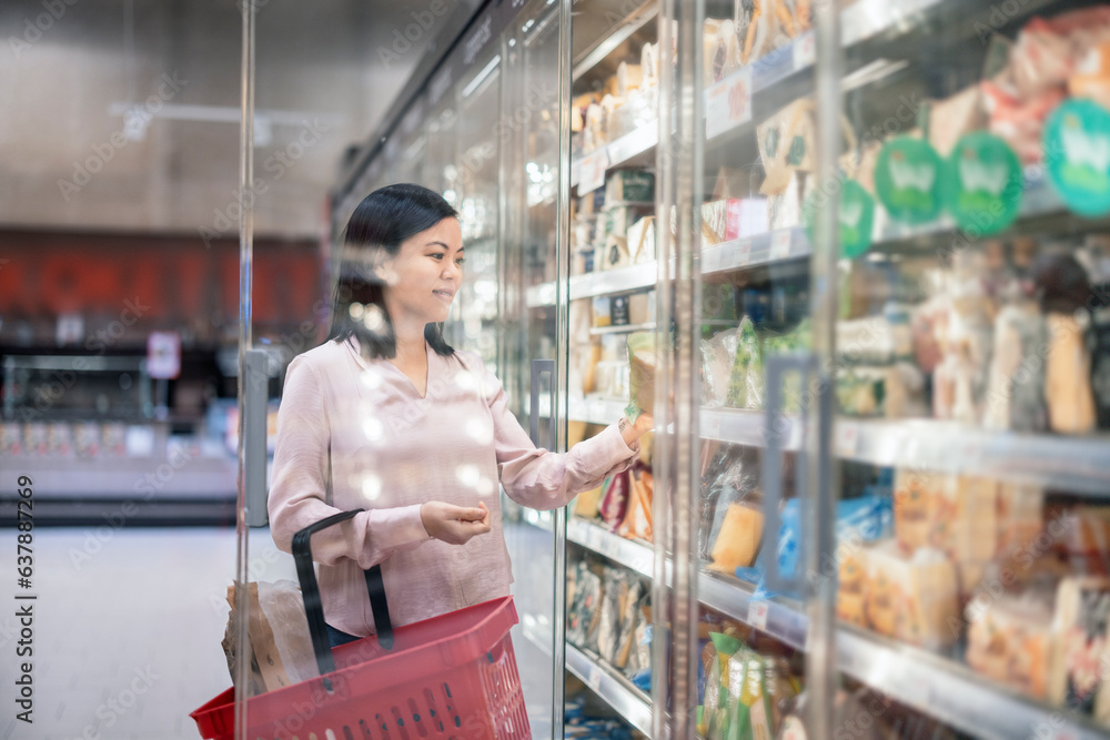 Young woman shopping during inflation in supermarket Young woman shopping during inflation in supermarket