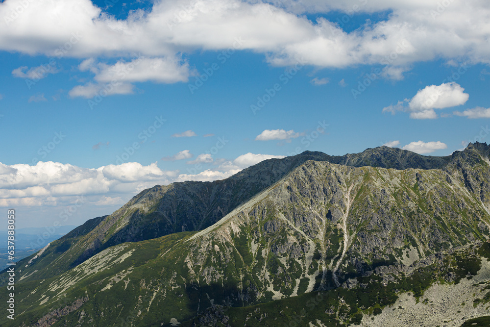Top of a stone mountain close up on a summer sunny day with blue sky. Poland, Zakopane, Tatry Top of a stone mountain close up on a summer sunny day with blue sky. Poland, Zakopane, Tatry