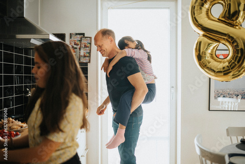 Father and daughters getting ready for birthday party