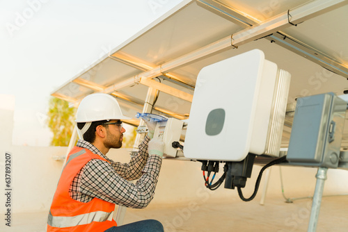 Engineer installing solar panels working on the electrical connection photo