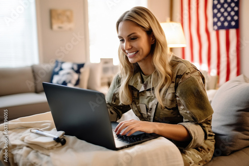 Patriotic female soldier video chatting with her family on a laptop photo