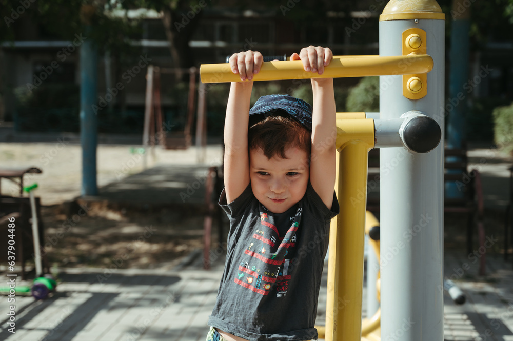 kindergarten child boy playing with a simulator on playground kindergarten child boy playing with a simulator on playground
