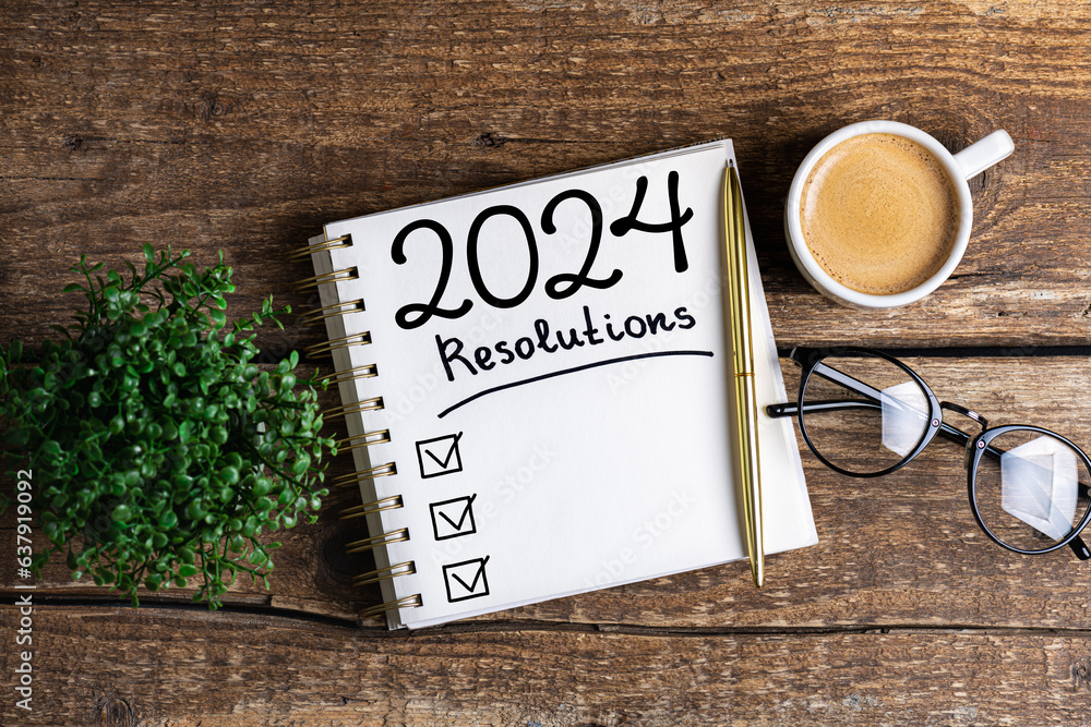 New year resolutions 2024 on desk. 2024 resolutions list with notebook, coffee cup on table. Goals, resolutions, plan, action, checklist concept. New Year 2024 template, copy space - obrazy, fototapety, plakaty 