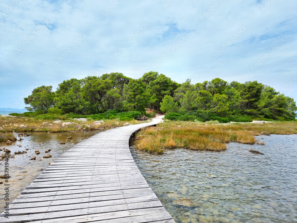 Wooden footpath over sea in Croatia, Sibenik. Wooden trail over water. Winter time. Wooden path.