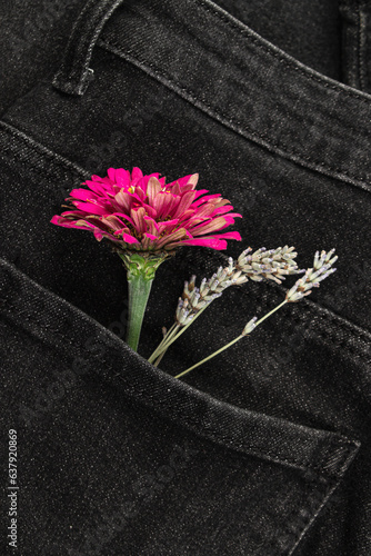 Flowers in the pocket of black jeans