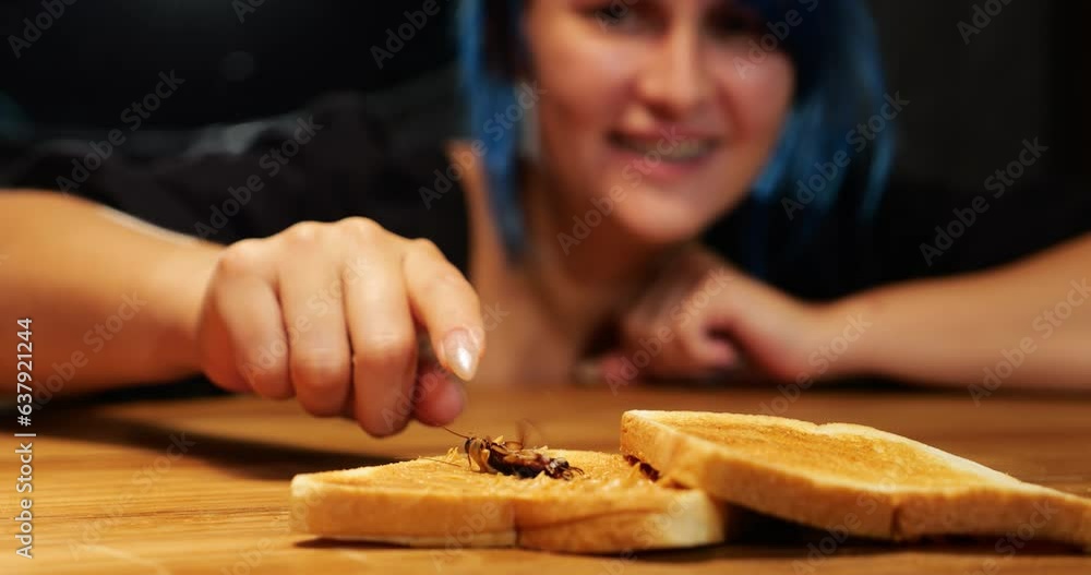 Ugh, that's disgusting. Woman found big cockroach in peanut butter sandwich. Selective focus shot, blurred lady on background, reach out hand and scary to touch bug leg. Roach jerks its paws