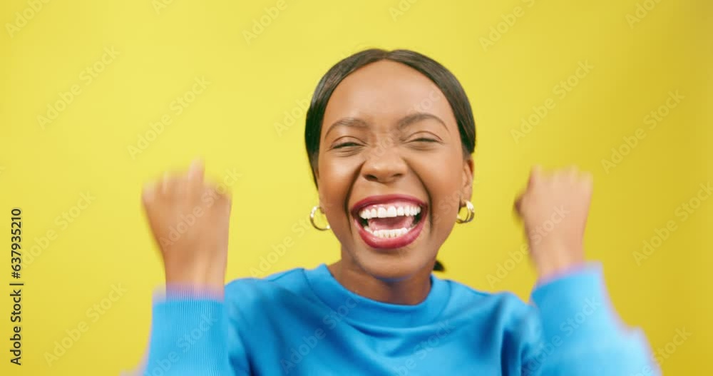 Excited woman cheers, winning happy dance, yellow studio background Excited woman cheers, winning happy dance, yellow studio background