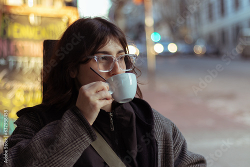 woman drinking coffee in a coffee shop in the city 