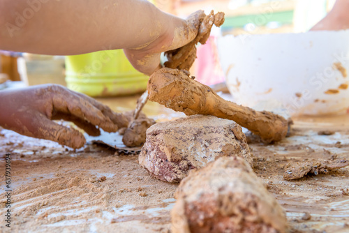 Photos child modeling natural clay from crushed clay rocks with sculpting tools