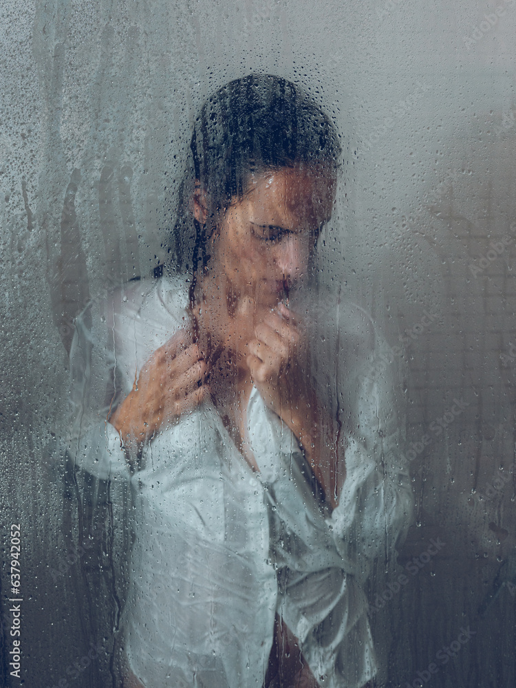 Woman near wet door in shower cabin