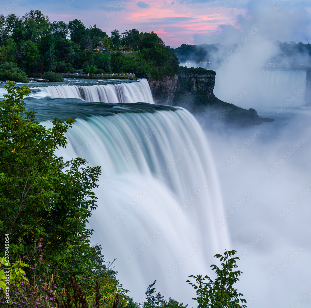 A long exposure photo waterfalls in the state park Niagara Falls in cloudy dusk.