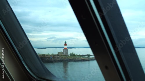 View from the window of the ship's deck to the sea islands and the lighthouse.