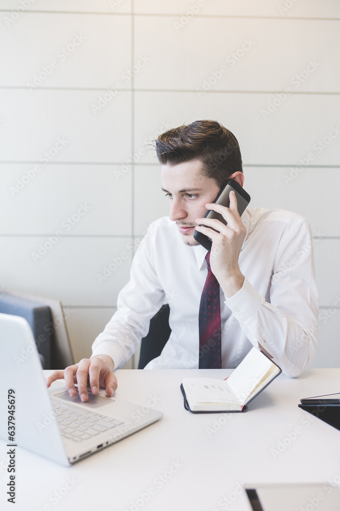 Young caucasian businessman talking smart phone Young caucasian businessman talking smart phone